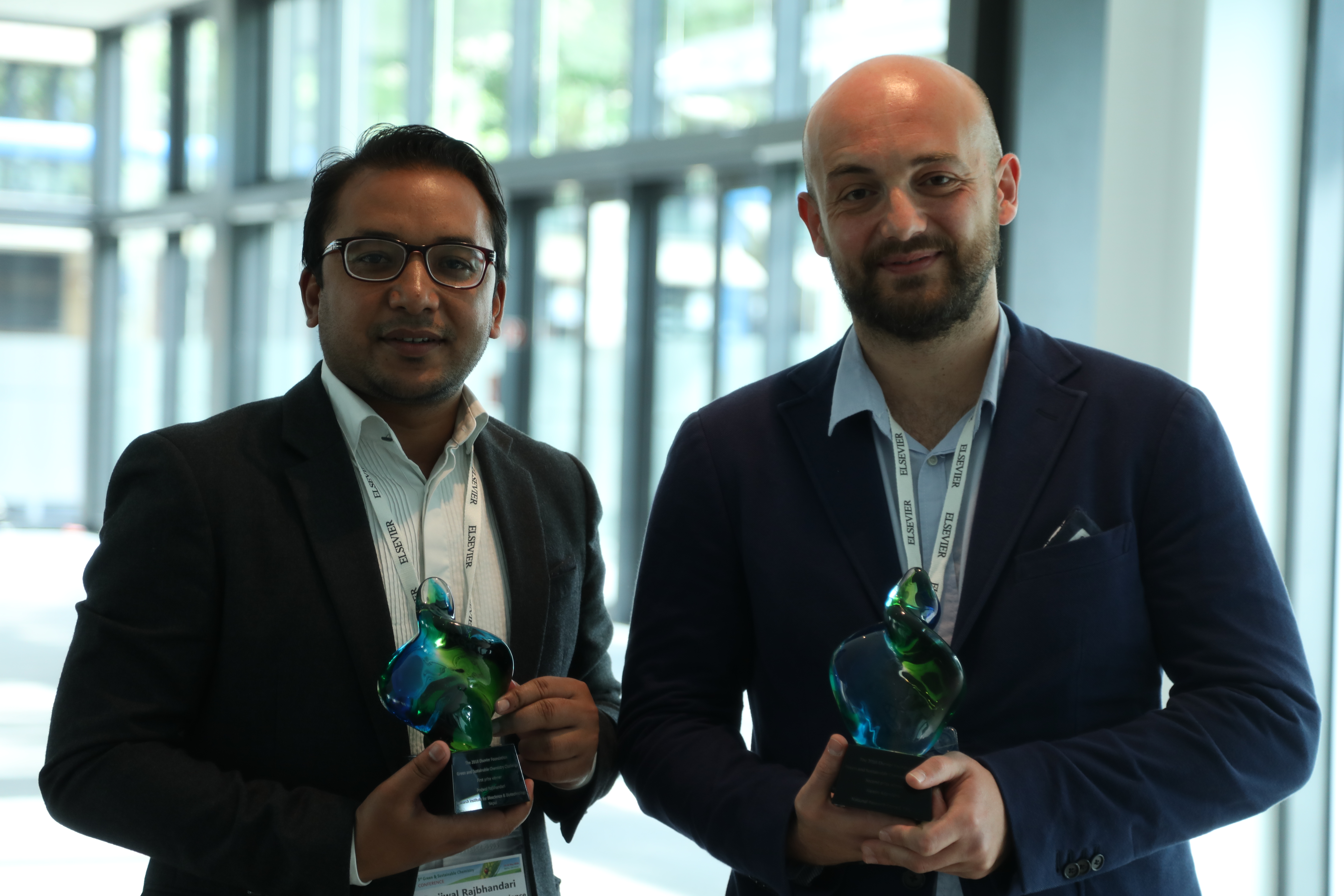 First prize winner Prajwal Rabhindari, President of the Research Institute for Bioscience & Biotechnology (RIBB) in Nepal, and second prize winner Dr. Alessio Adamiano, a researcher at the Italian National Research Council (CNR), pose with their awards.