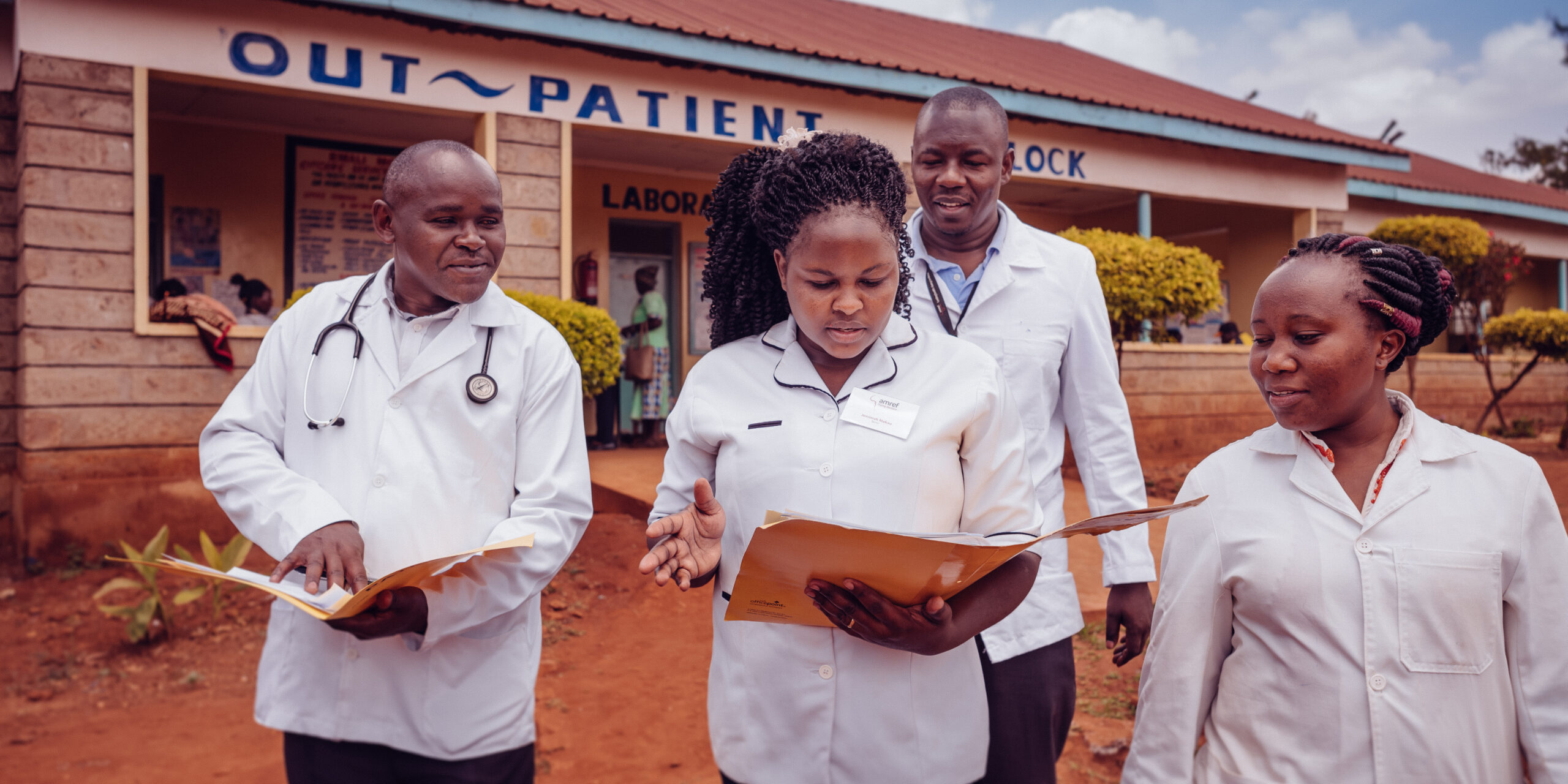 Amref health workers in front of hospital - Leap program